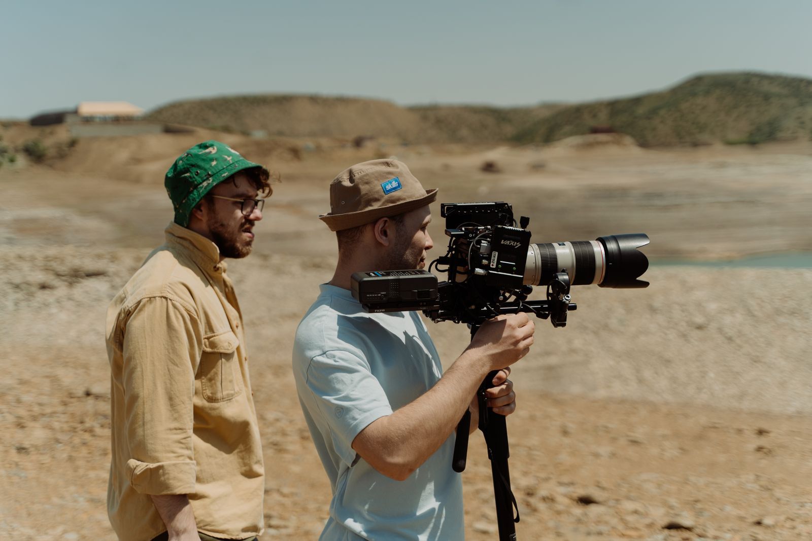 Two filmmakers shooting in a rocky desert
